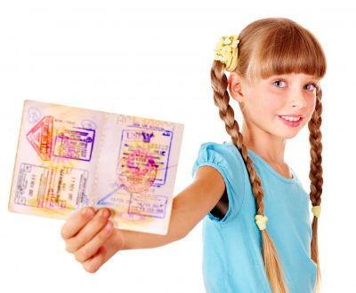 Little girl holding  passport. Foreign vacation.